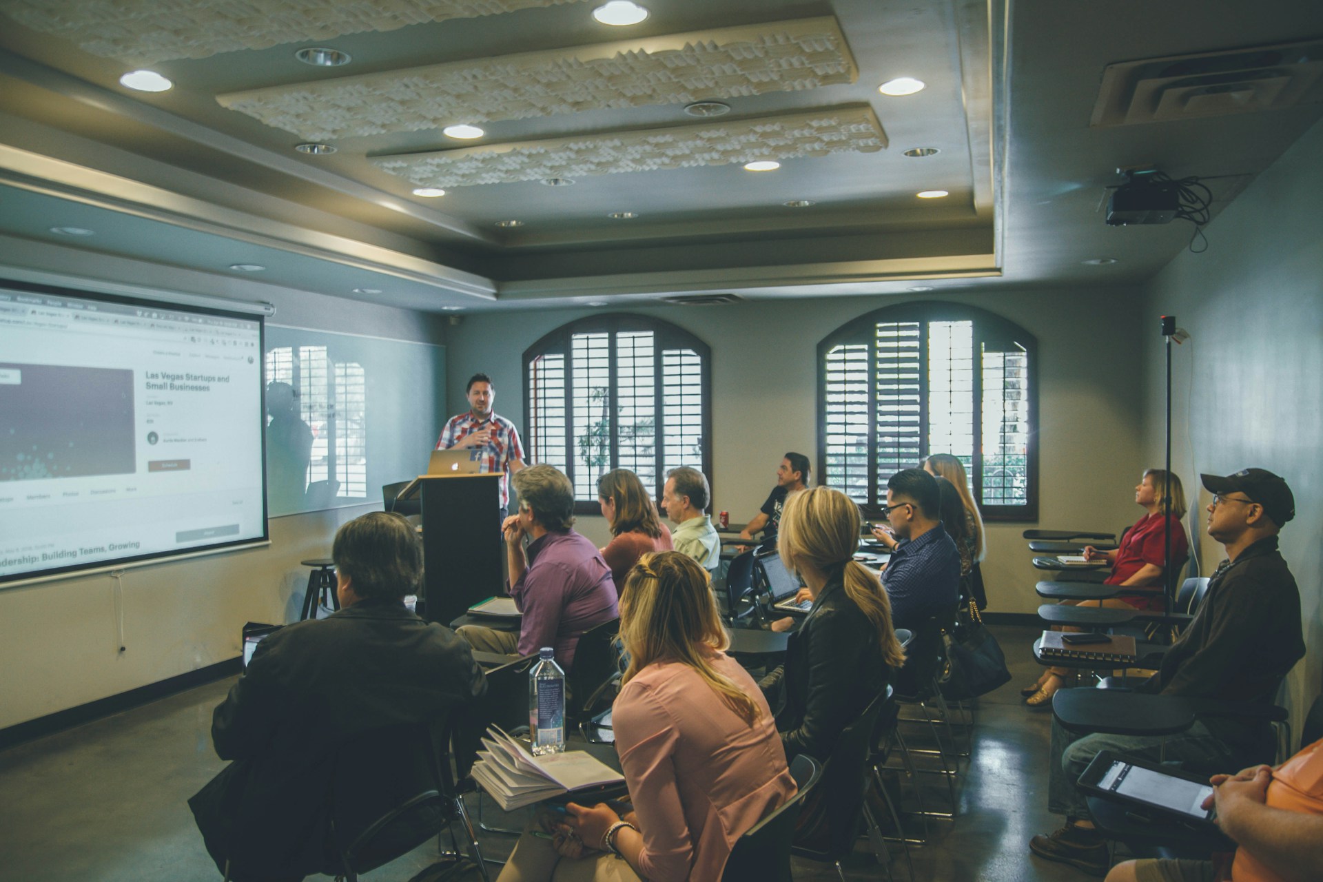 Technology trainer conducting corporate workshop with engaged audience